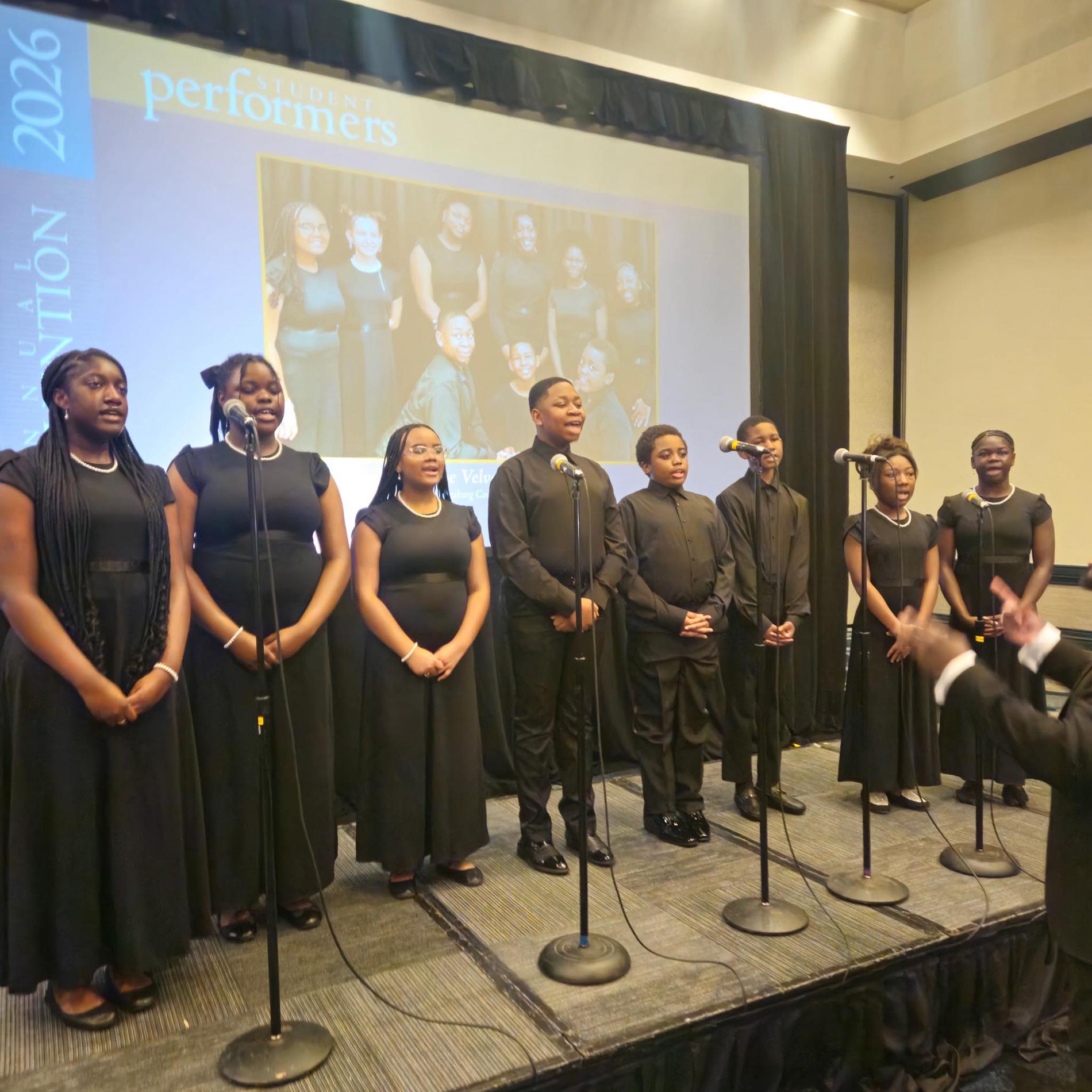 people singing in a choir in front of white screen