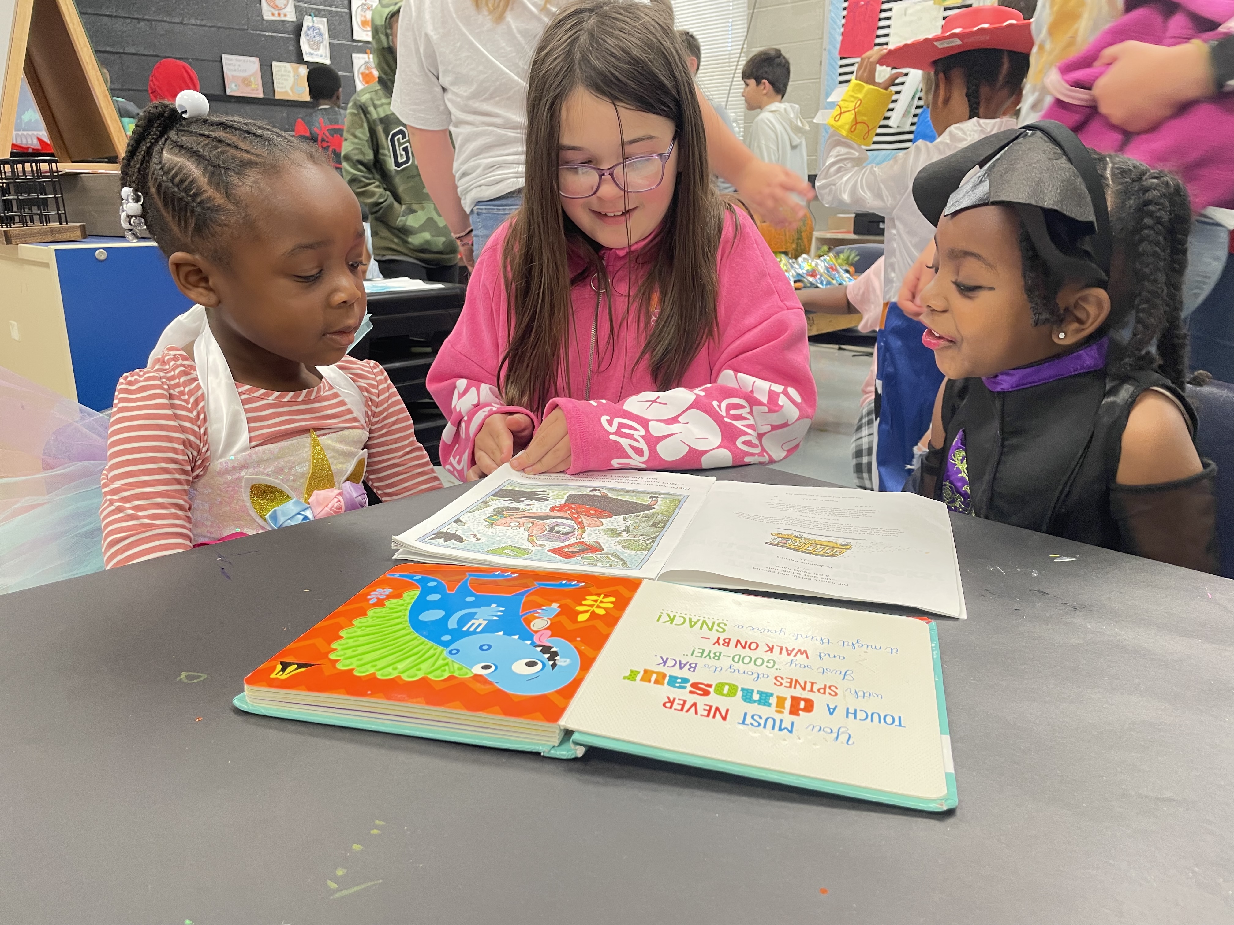 Older students pair with younger to read to them