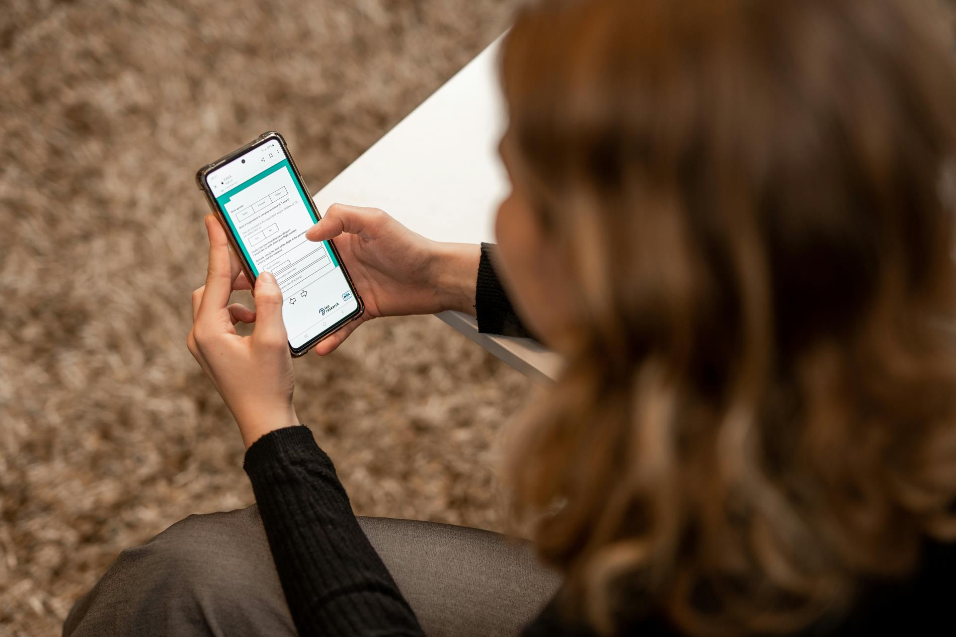 A woman takes a survey on her cell phone