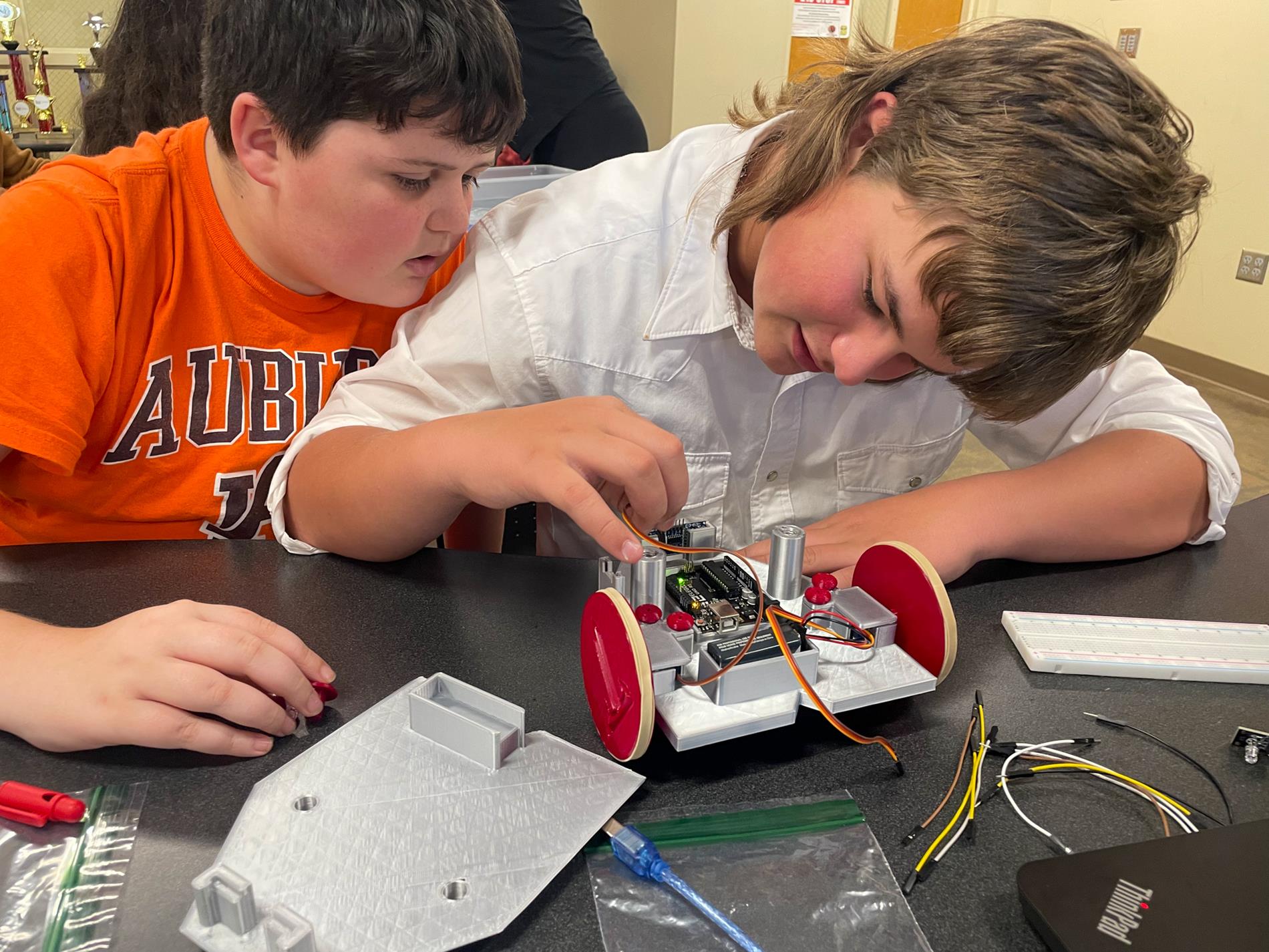 Troy University Electrical Engineering students help 8th-grade STEM students.