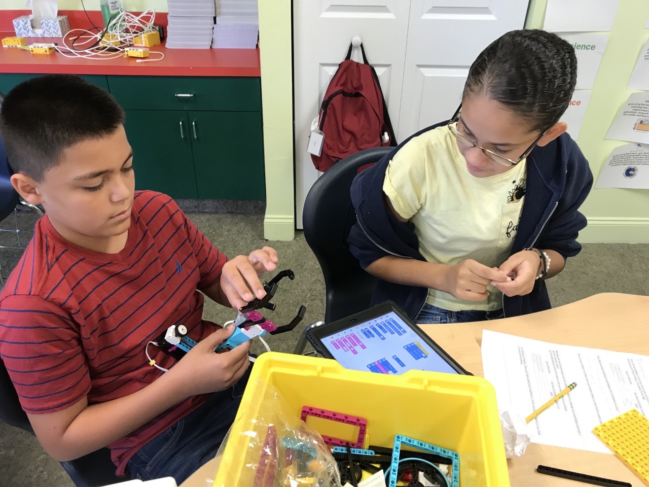 David and Julianna collaborate on coding their group's robotic arm.
