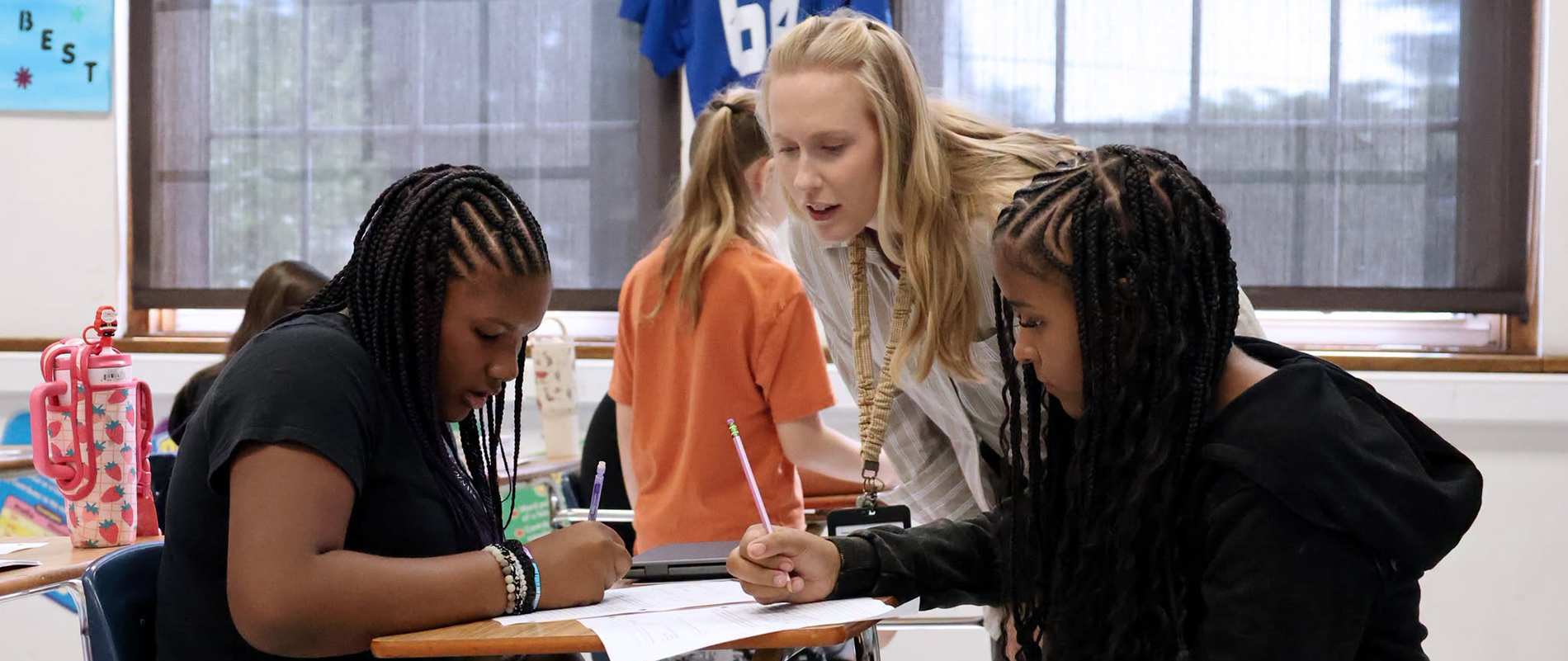 Teacher working with students