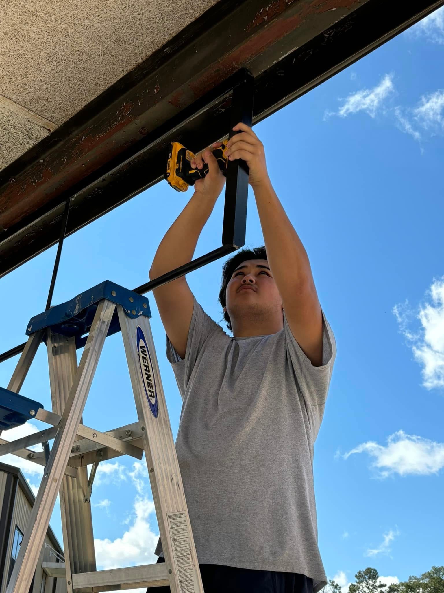 Welding student building pull up bar