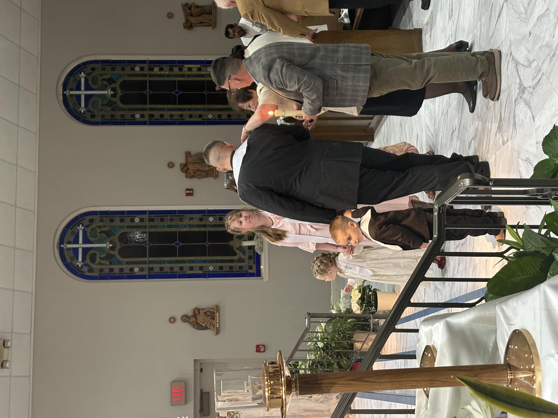New Catholics process to the front of the church