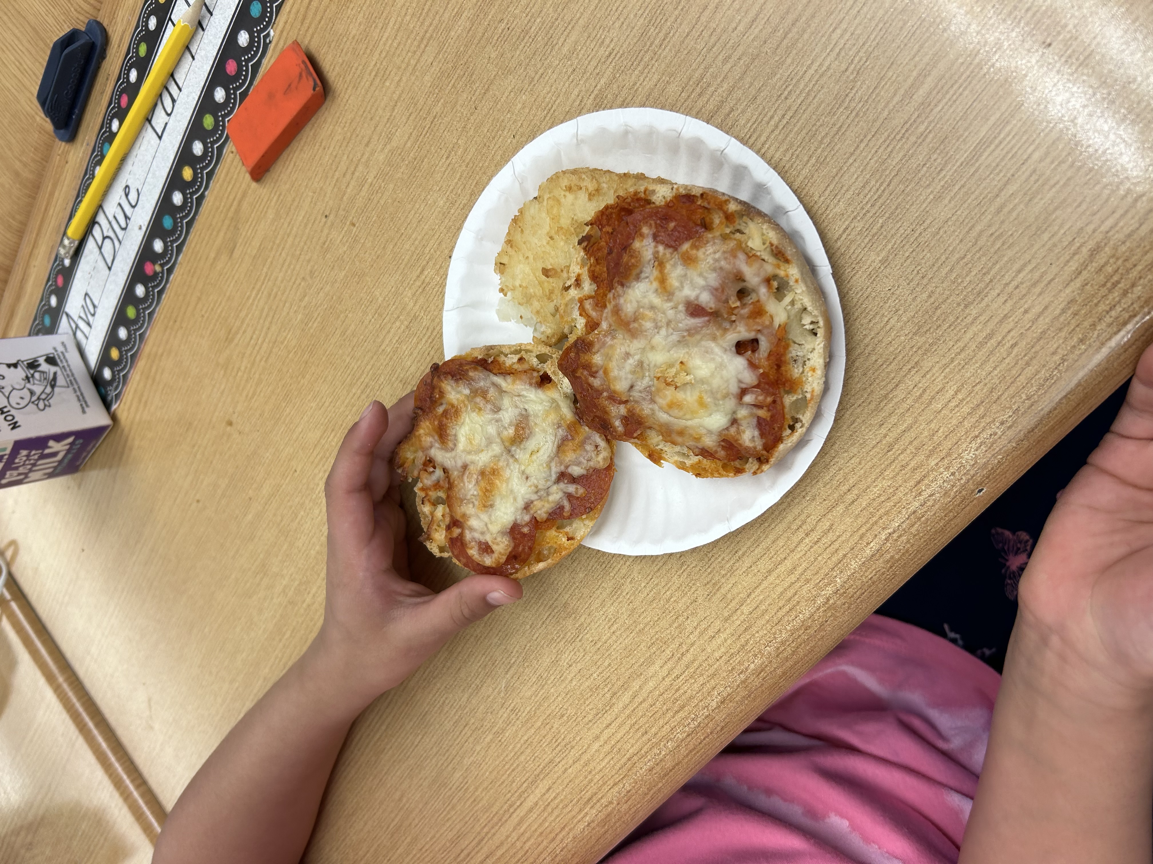 Student holding their pizza they made