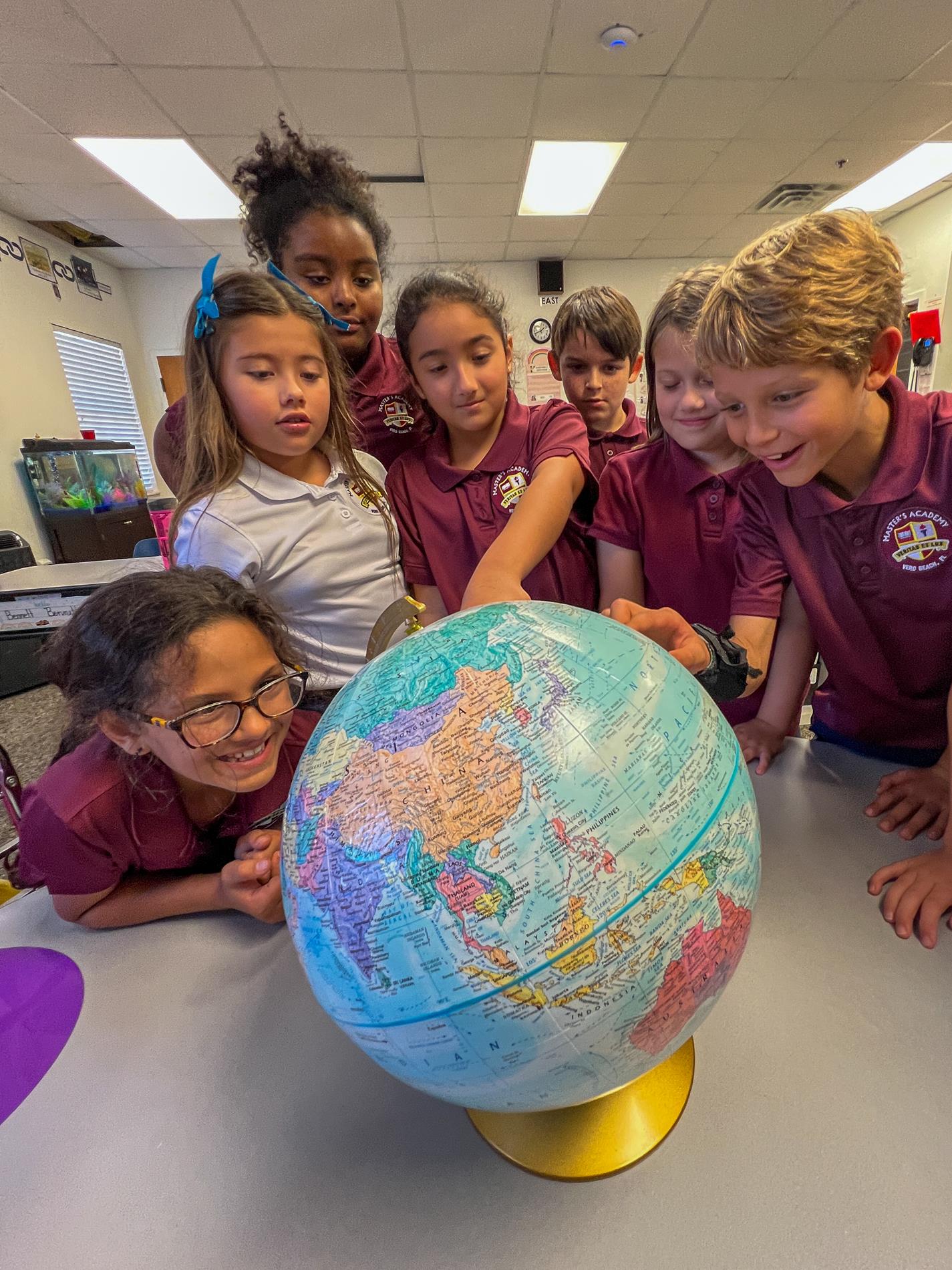 Students looking at globe
