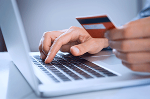 image of man paying bill online using credit card