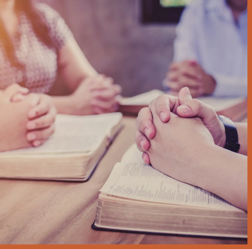 hands on bible praying hands on bible praying