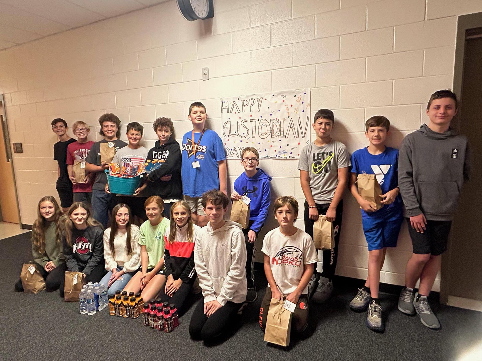 MS class holding gifts for custodians