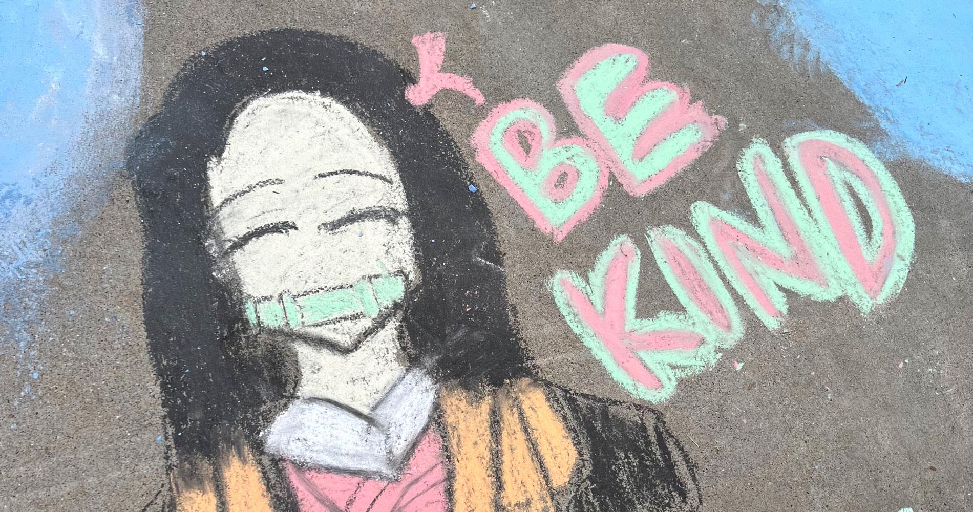 chalk drawing of a girl with the words Be Kind