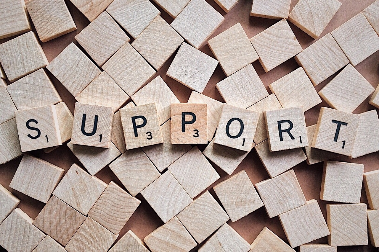 the word support on scrabble tiles