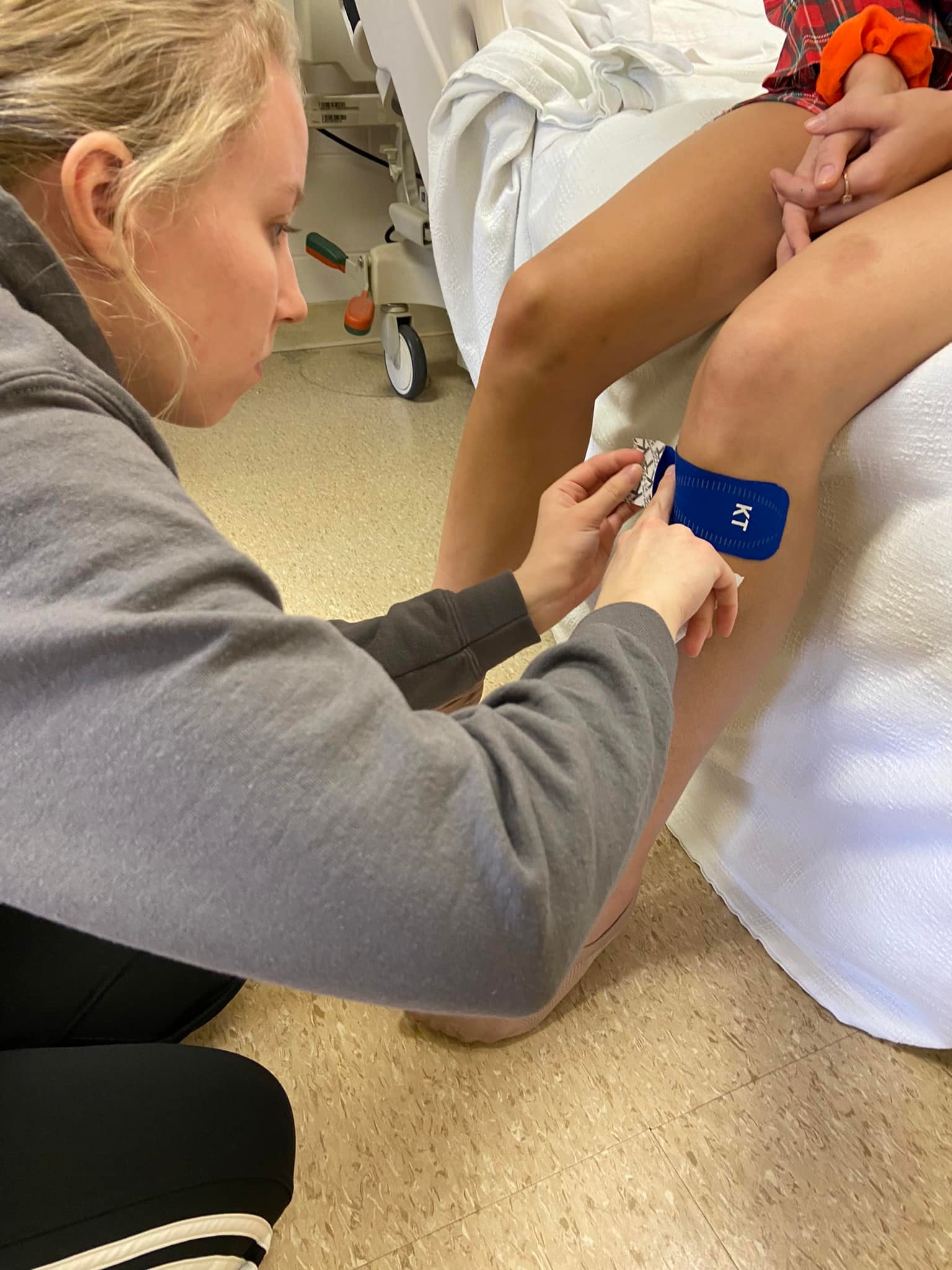 Personal training student is learning how to tape for an injury