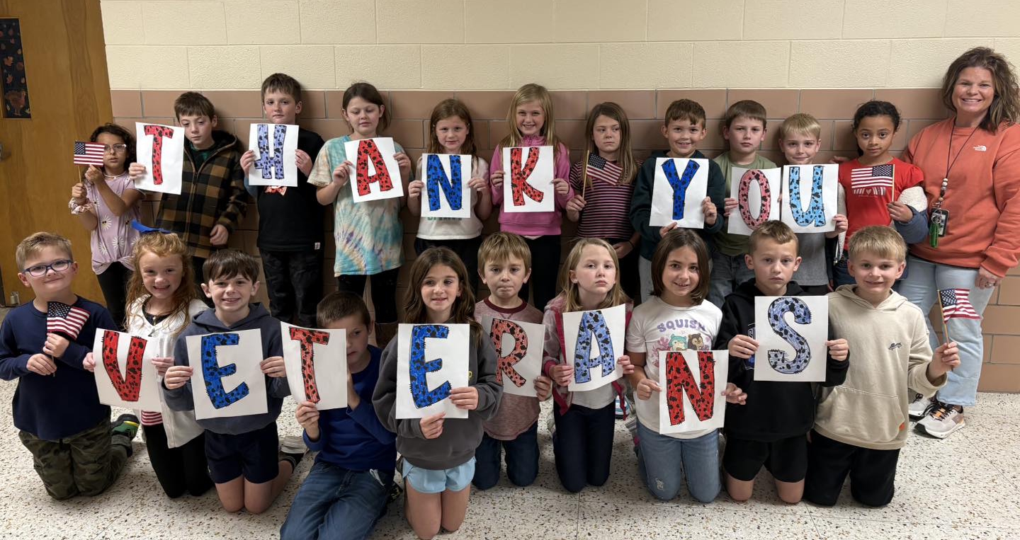 Mrs. Barnes students holding a thank you veterans sign.