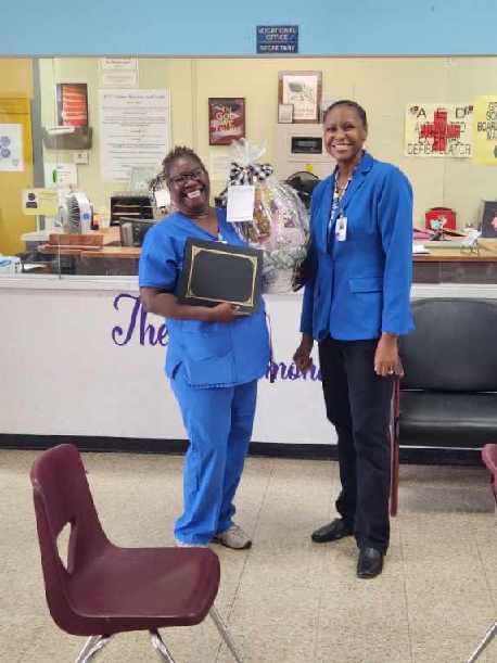 Dr. Kandice Jernigan presents Ms. Carolyn Hardy a basket from the GTC Staff for National Custodian Day 2023.