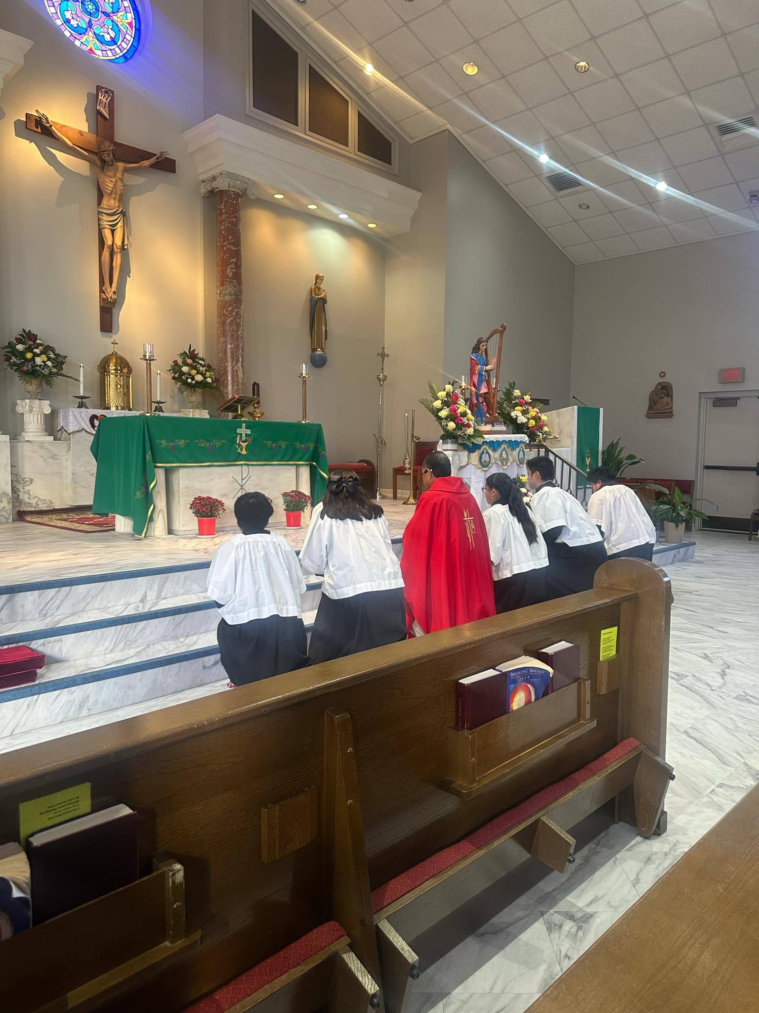 Father and altar servers at the altar