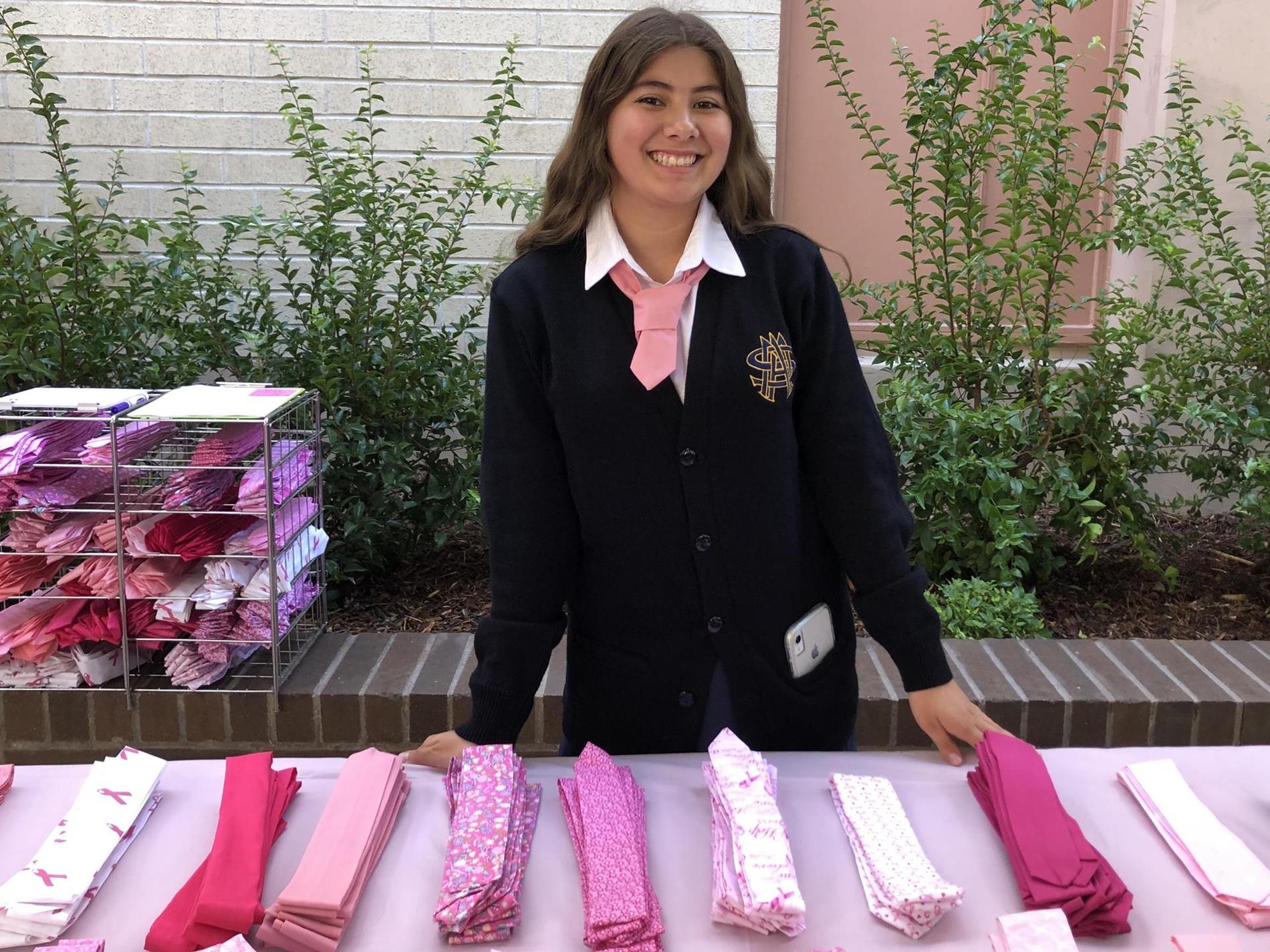 student selling pink ties