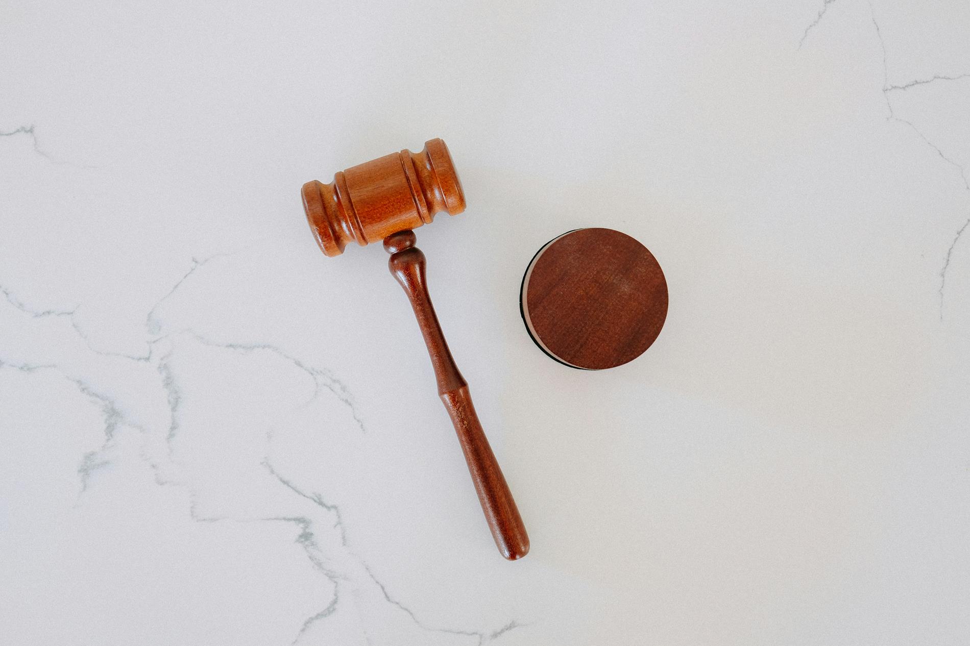 A gavel sitting on a white marble table