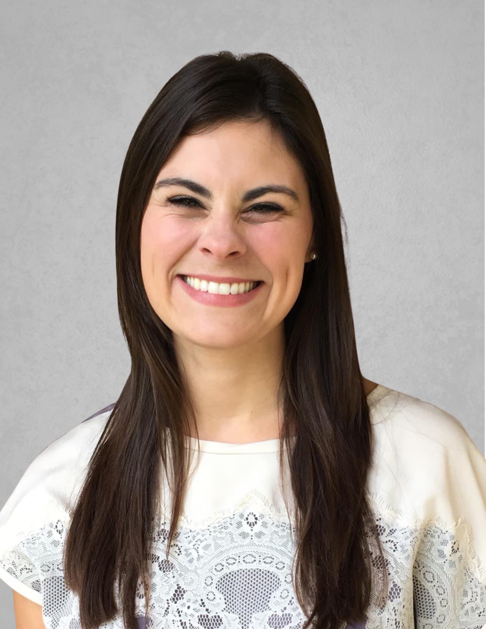 Professional headshot of Dannon Dauzat smiling and facing the camera. She is wearing a cream-colored blouse with lace detailing across the front. Dauzat has long dark brown hair and is posed against a light gray background. The portrait is suitable for use in a school leadership or administrative appointment announcement.