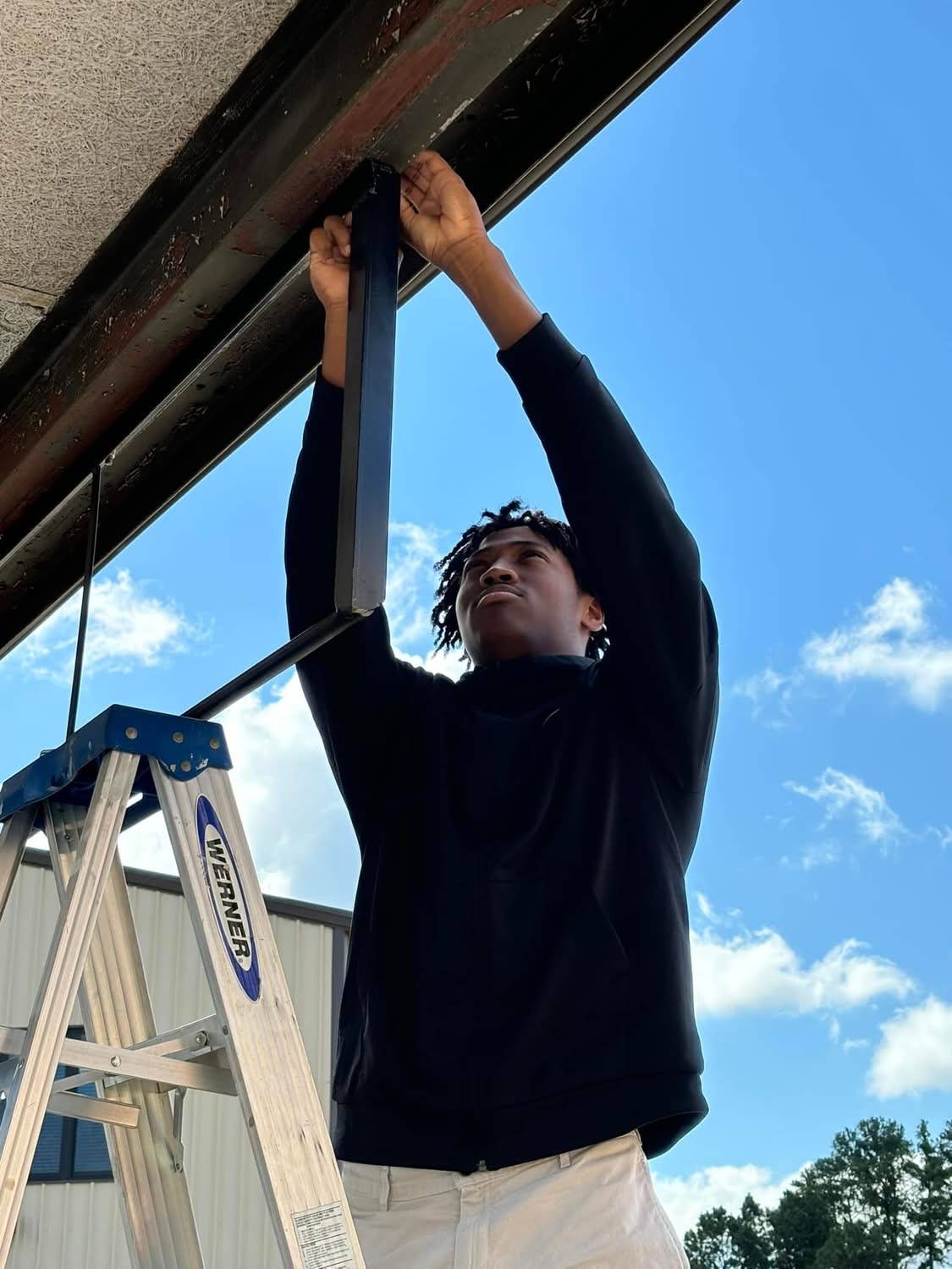 Welding student working on Pull up bar