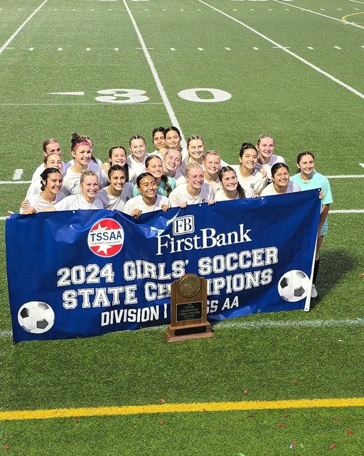 soccer team holding up a banner