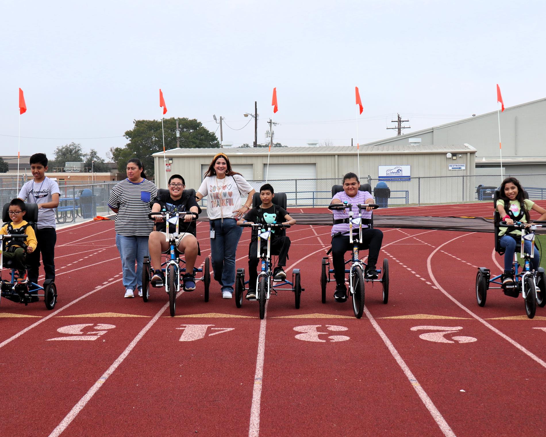 Students riding the adaptive bikes donated to the school