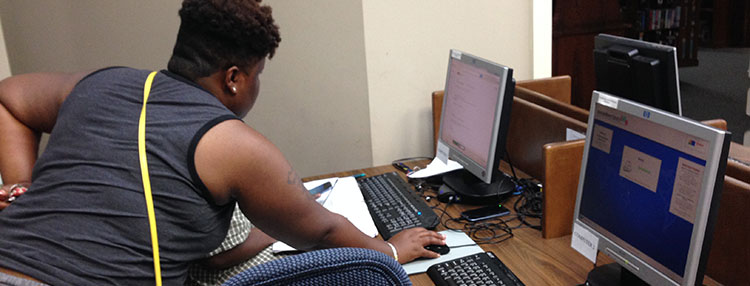 Teacher with student at computer