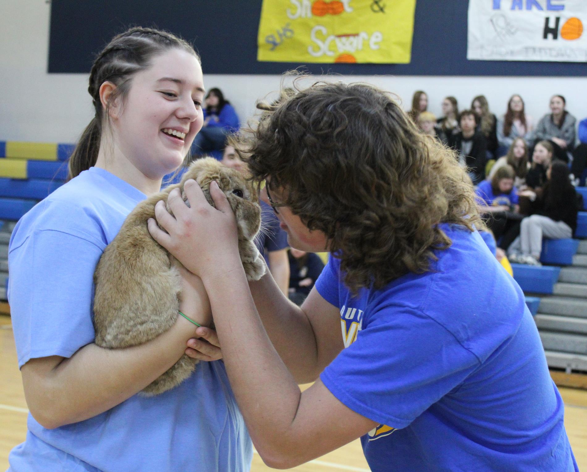 senior Aiden Brothers and senior Josie Stanely giving the rabbit a little kiss for a good cause