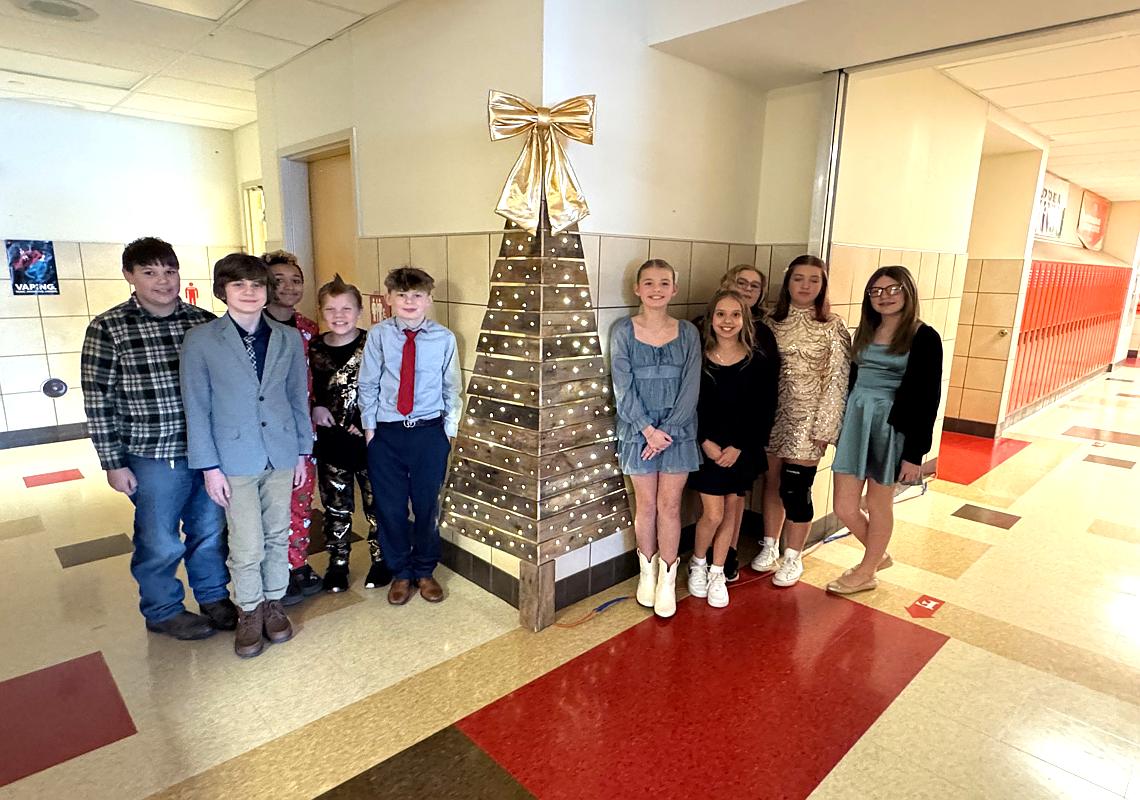 6th grade Students pose with the “Pallet Tree” they made in Mr. Scalises’s Wellness Plus Class