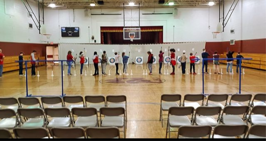 archery team lined up to shoot archery team lined up to shoot