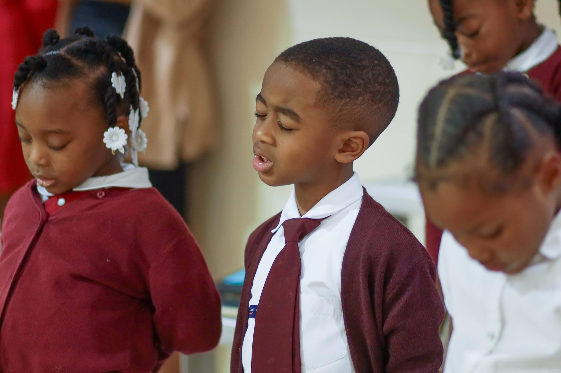 Children bowing head in prayer