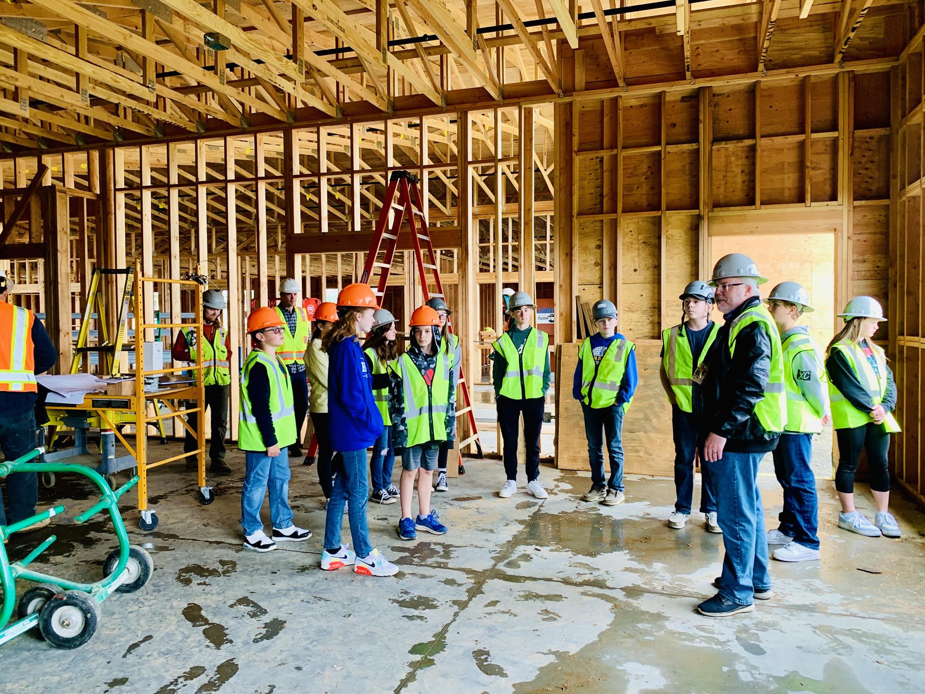 A small group of Hilda Lahti students touring the construction site of the new middle school. 