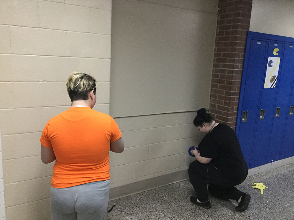 Students volunteering to help paint