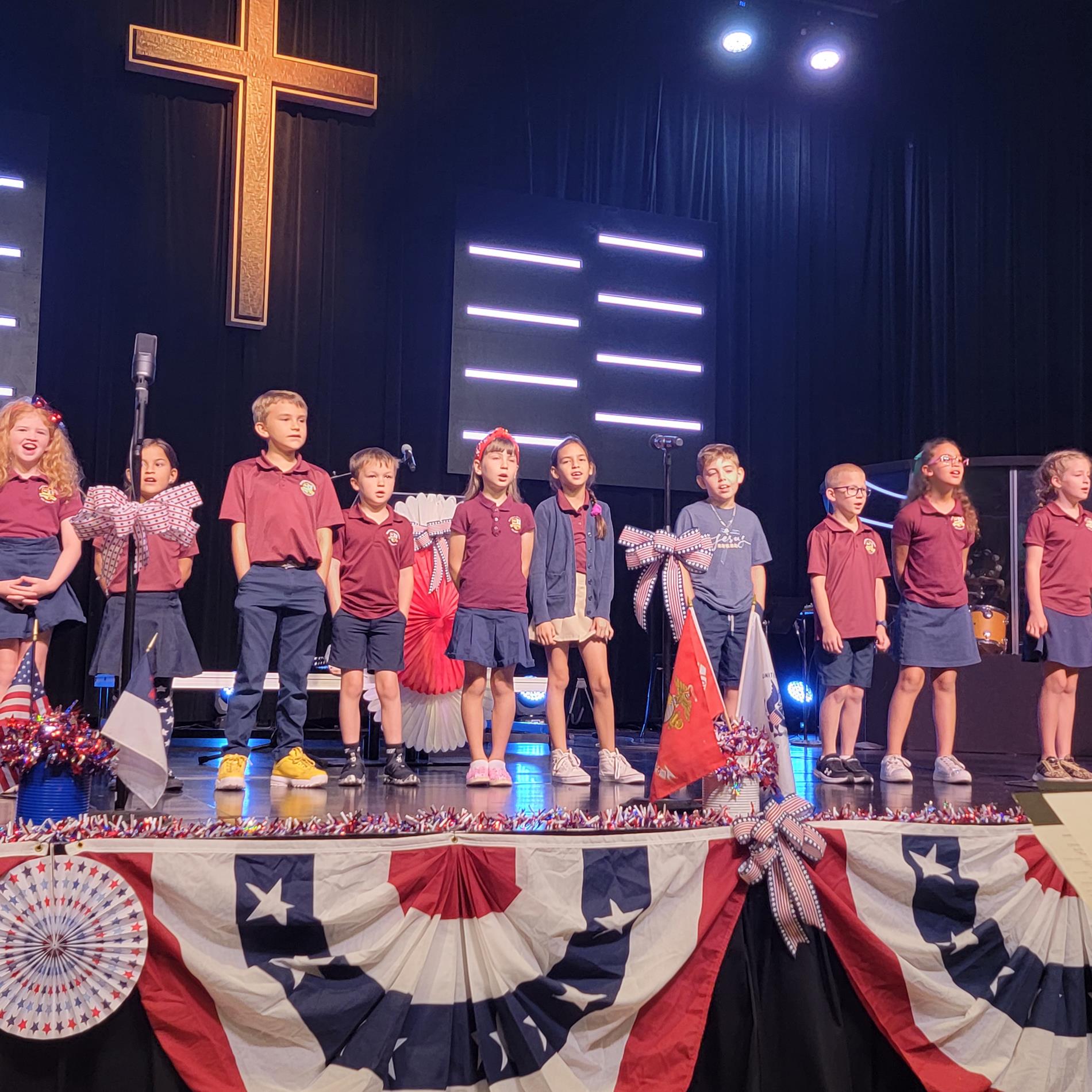 lower school students on stage singing