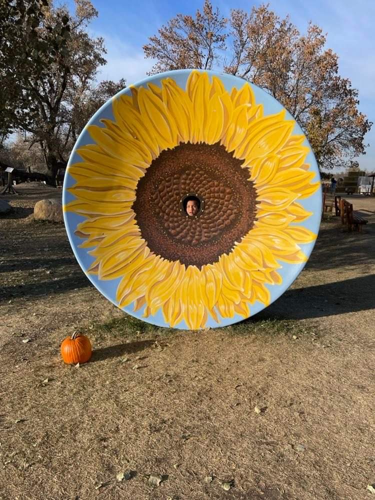 Students face in the giant sunflower