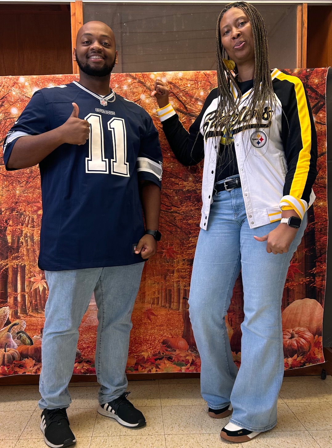 The principal and staff member pictured with jerseys.