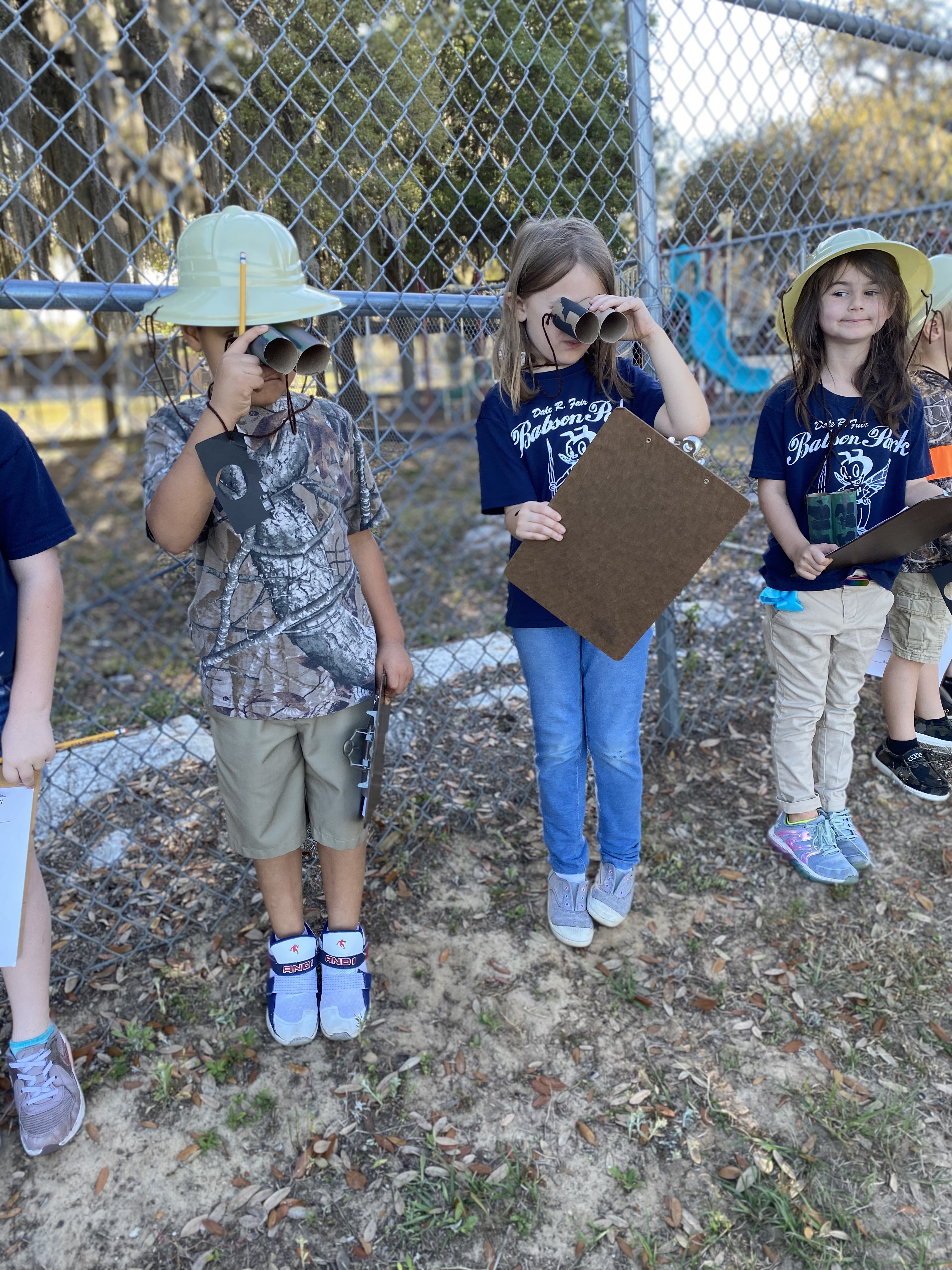 Kindergarten students looking for animals while on their safari.