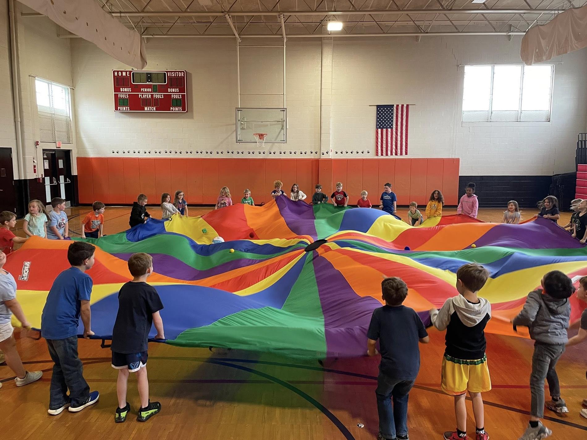 CES Students in gym with a parachute