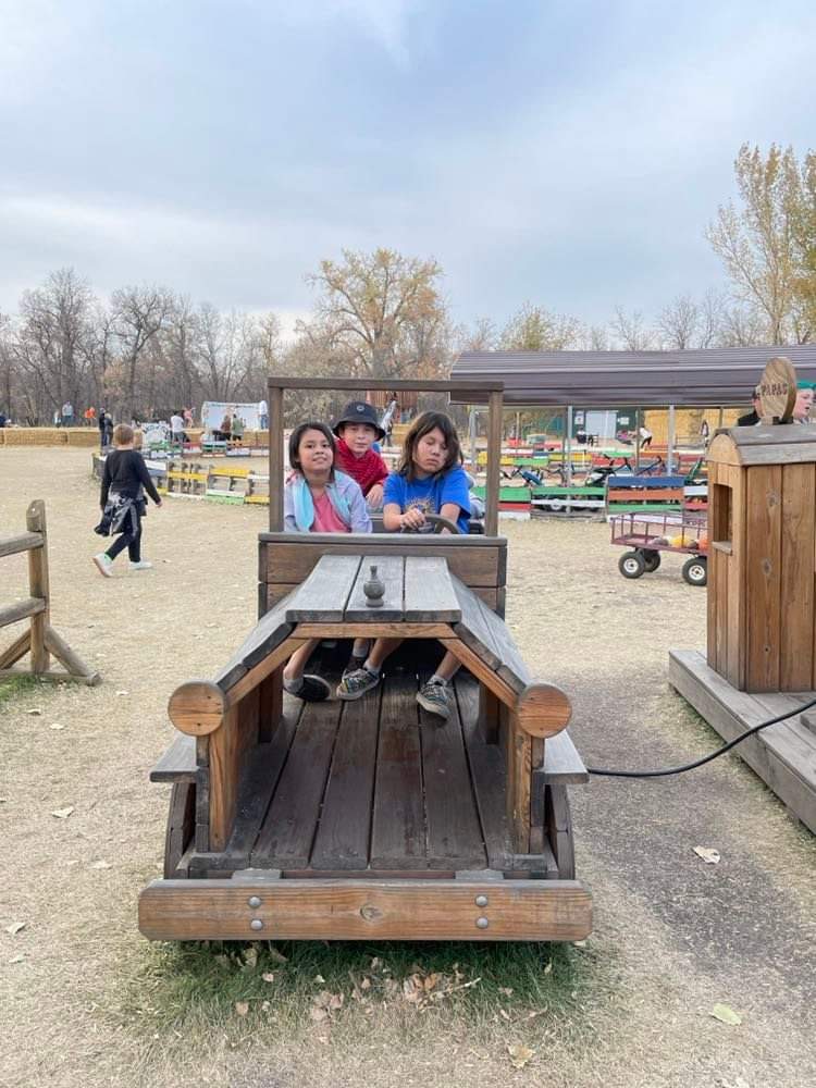 More students in the wooden play truck