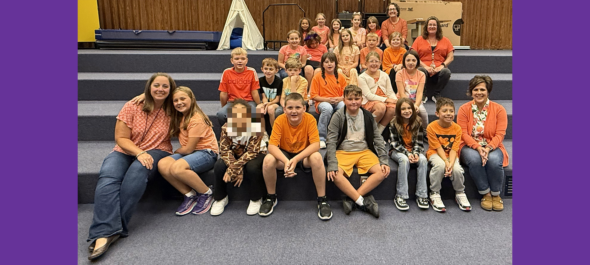 Elementary students dressed in orange to raise awareness for hunger action month