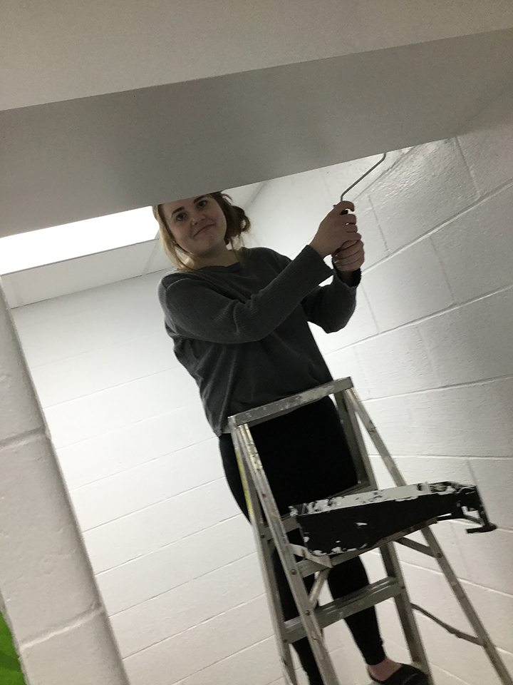 Students volunteering to help paint
