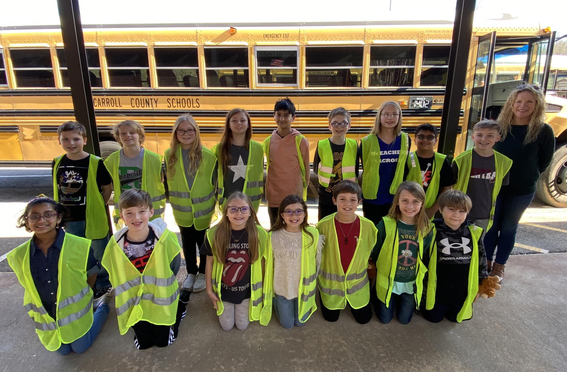 Safety patrol club in front of a school bus
