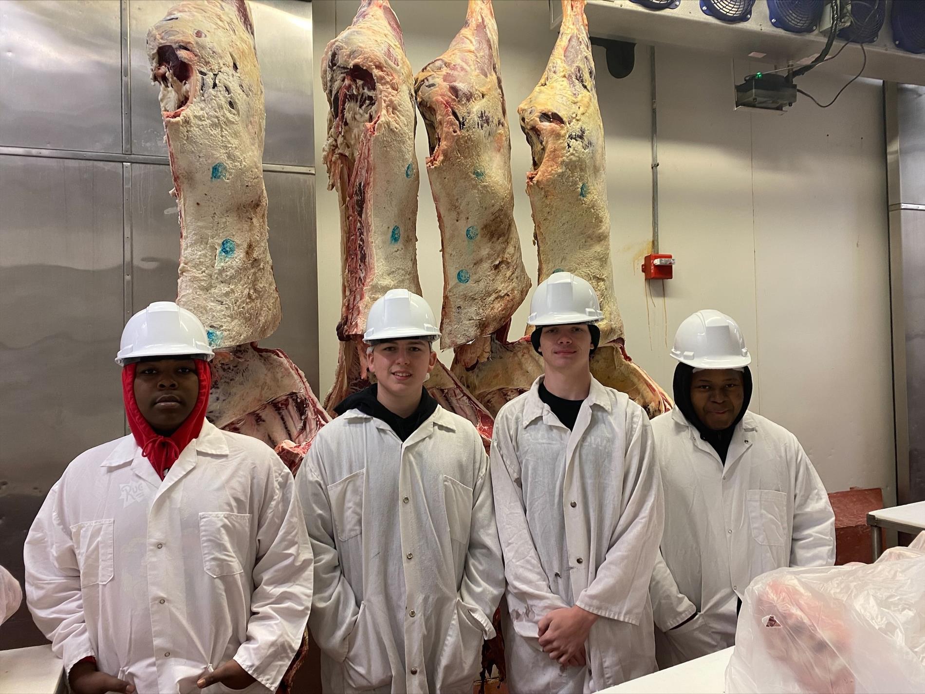 FFA students in cooler with animal carcasses 