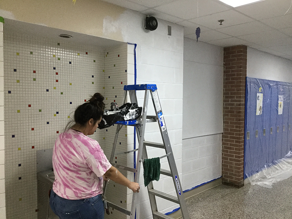 Students volunteering to help paint