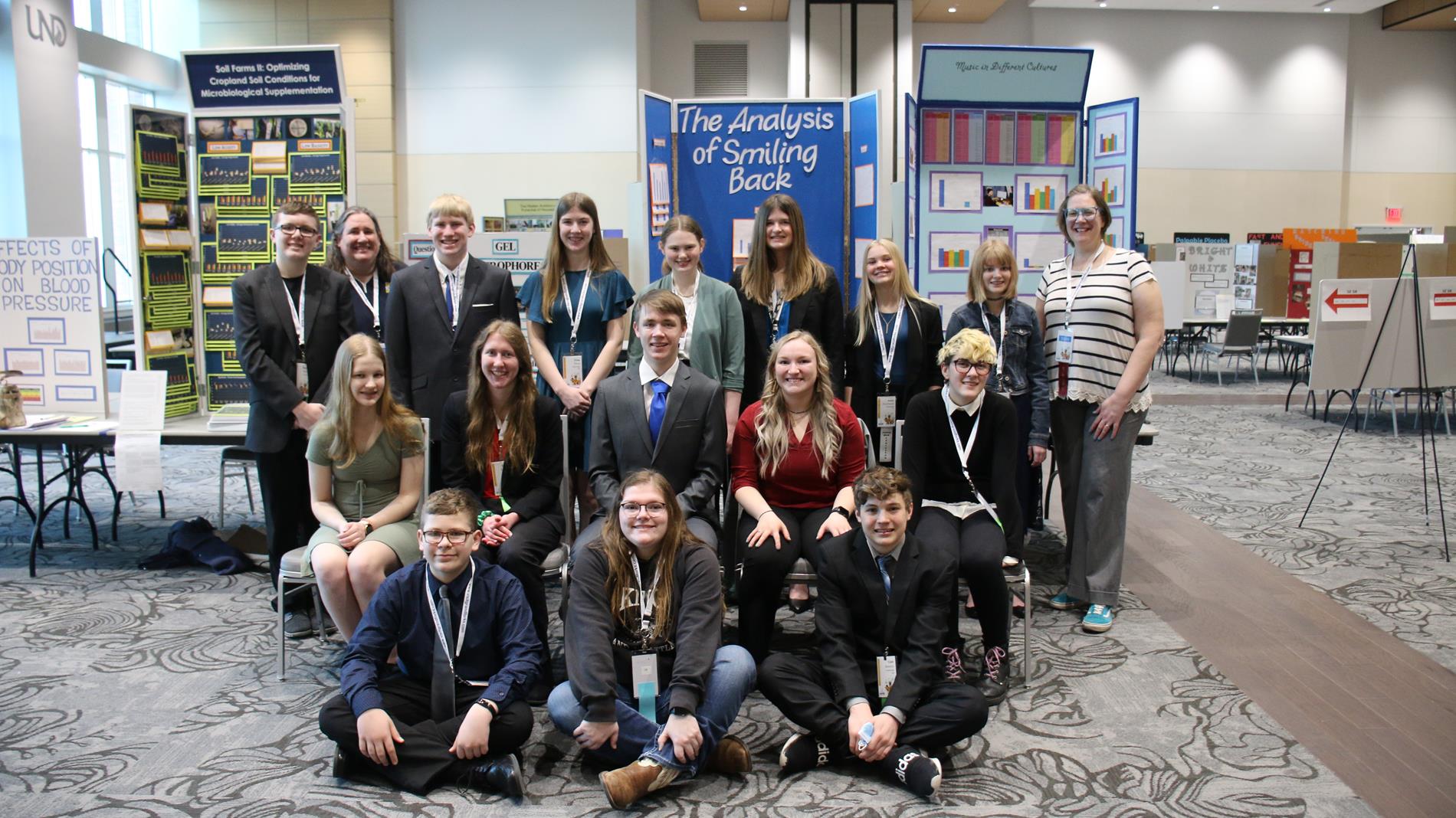 Science fair students posing with medals