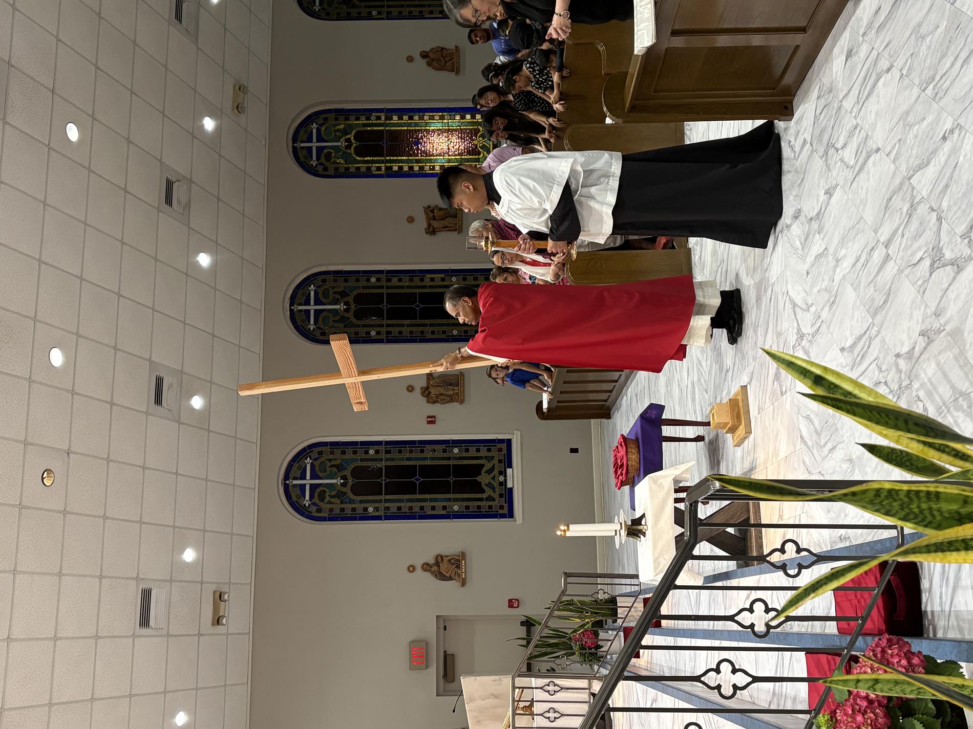 Father reaches the altar with the cross