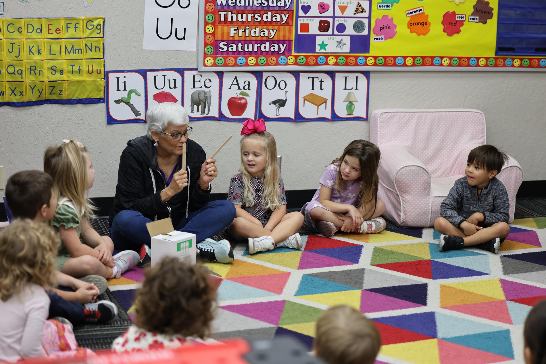 Teacher Sitting with Students