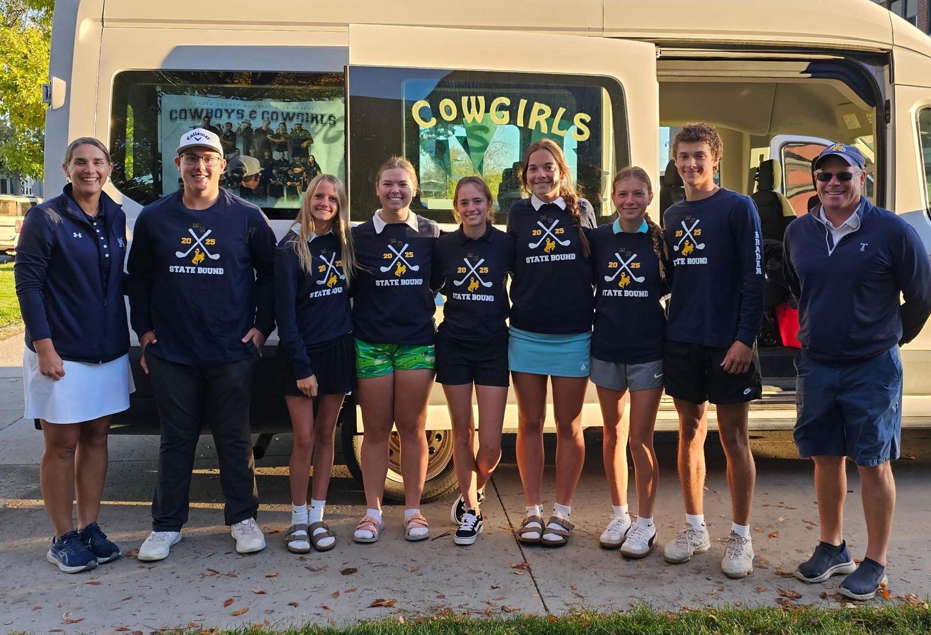 students standing in front of a bus