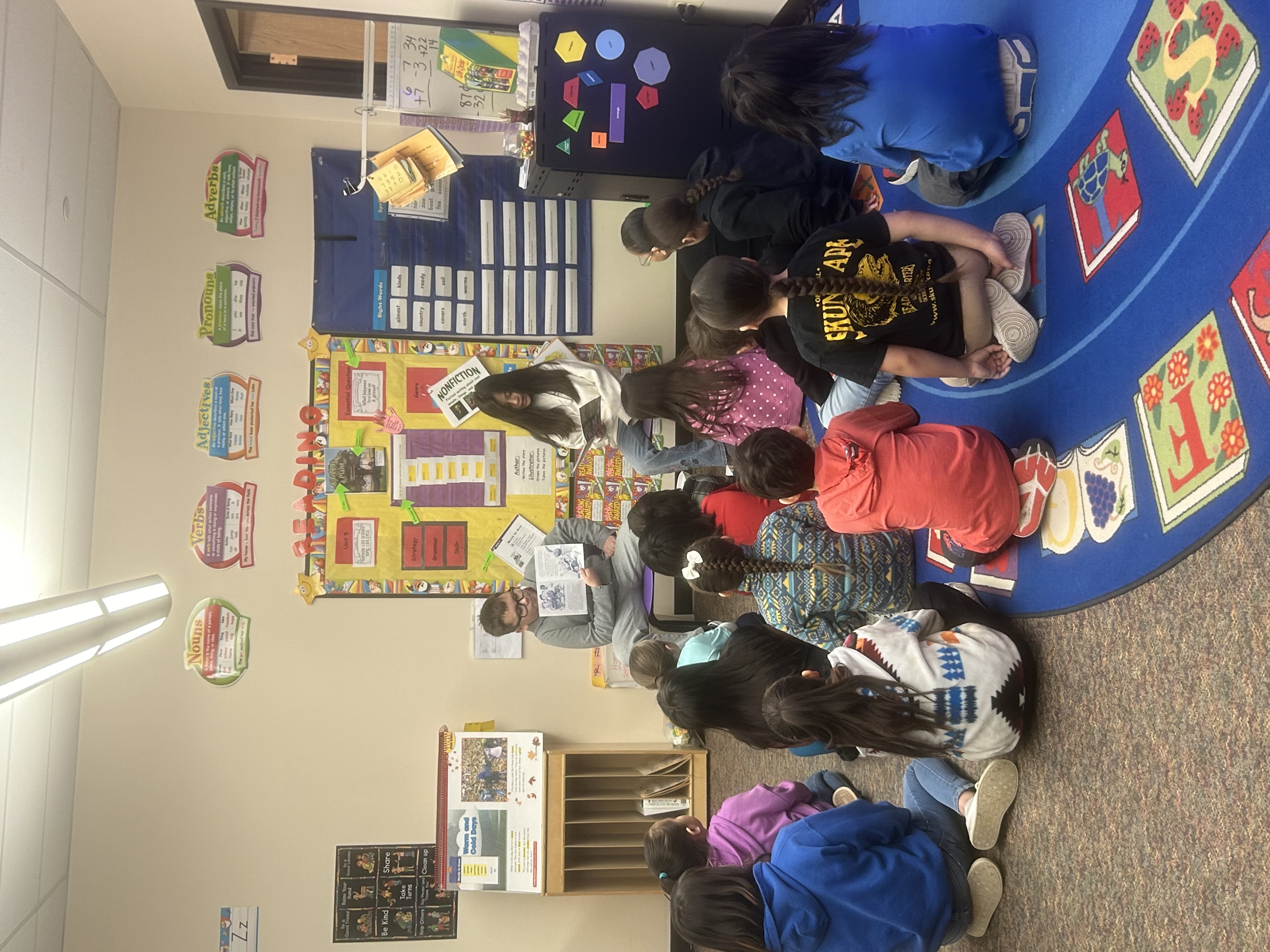 Students reading to younger students