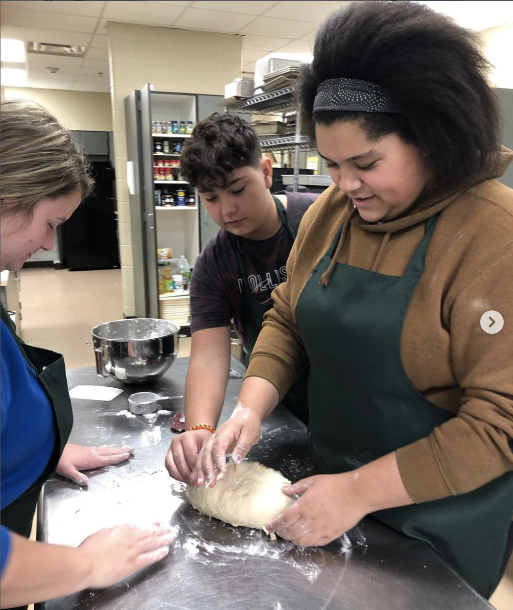 Culinary students making rolls