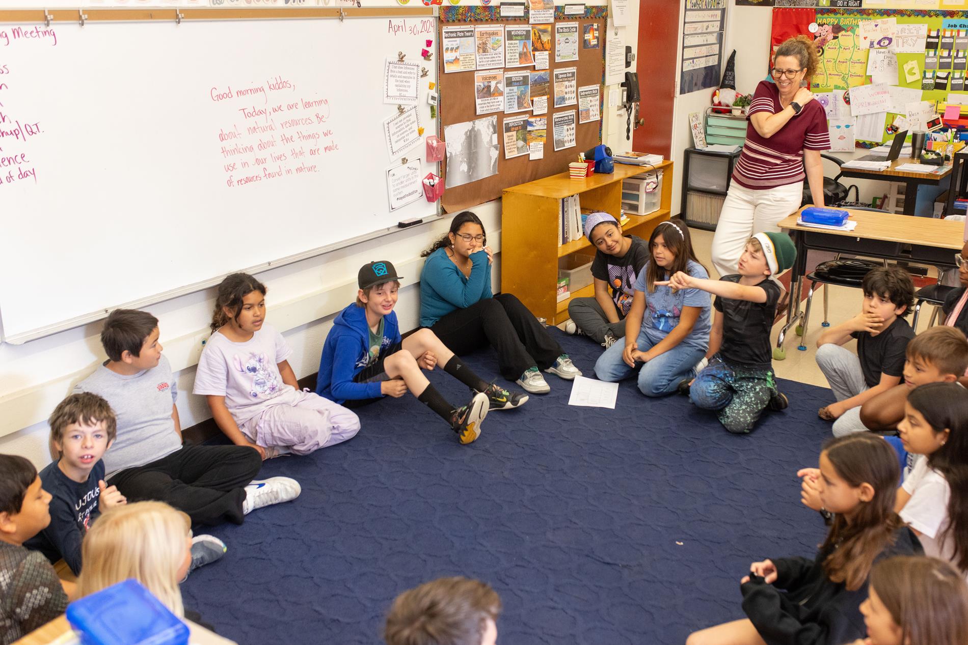 Students sitting on the floor in the classroom